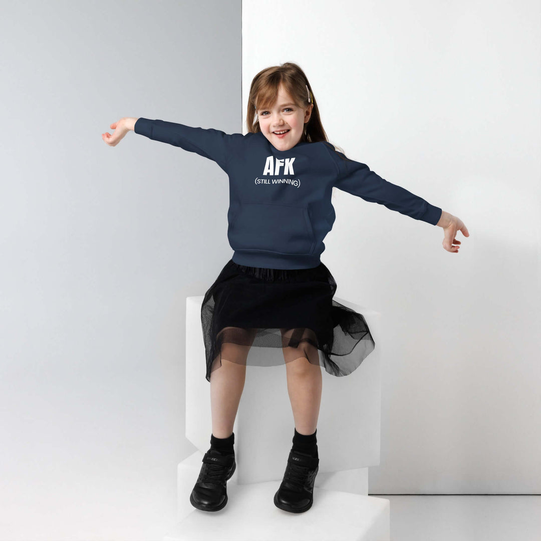 Girl wearing AFK Kids eco hoodie smiling while sitting on a step, showcasing a stylish and comfy eco-friendly kids hoodie.