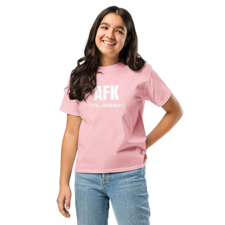 AFK Youth classic tee in pink worn by a smiling girl, highlighting its classic fit and trendy design.
