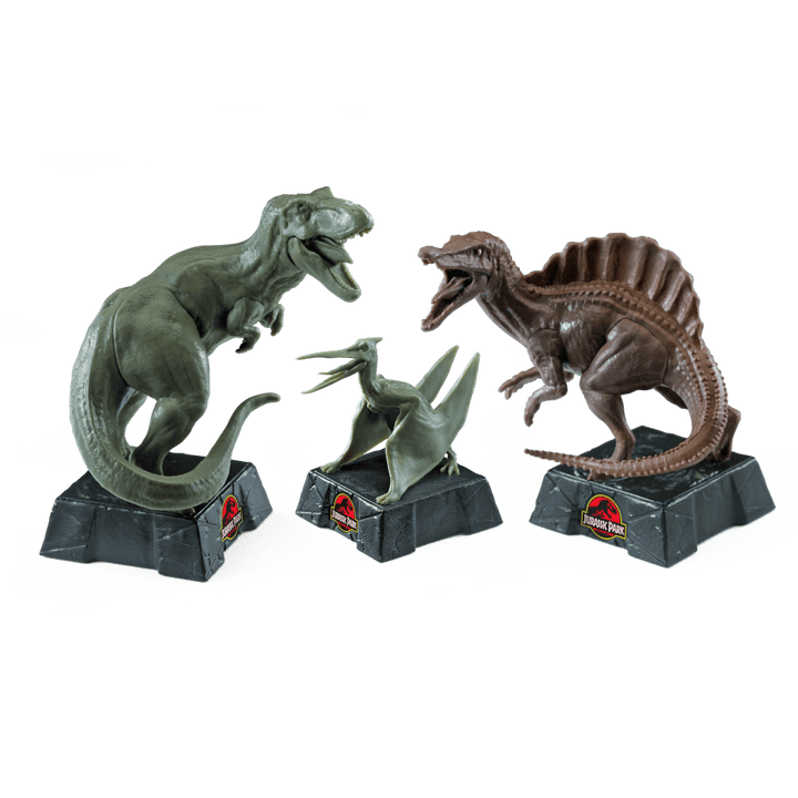 Jurassic Park Chess Set display featuring T-Rex, Spinosaurus, and Velociraptor dinosaur pieces.