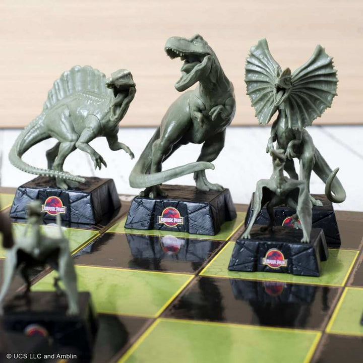 Jurassic Park Chess Set featuring sculpted dinosaur pieces including Tyrannosaurus Rex and Spinosaurus.
