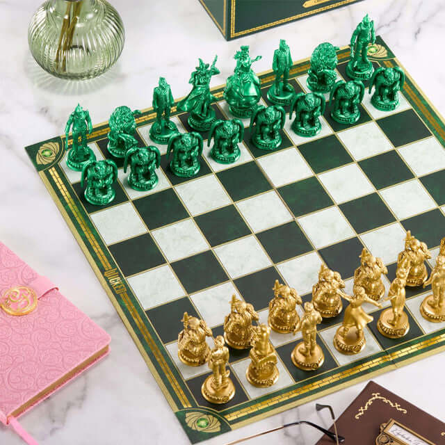 Wicked Chess Set featuring green and gold theme pieces on a chessboard, representing characters from Shiz University.