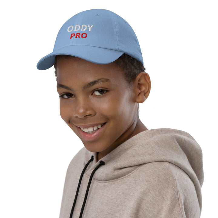 Boy wearing an Oddy Pro Youth baseball cap, smiling, showcasing the stylish design and comfortable fit.