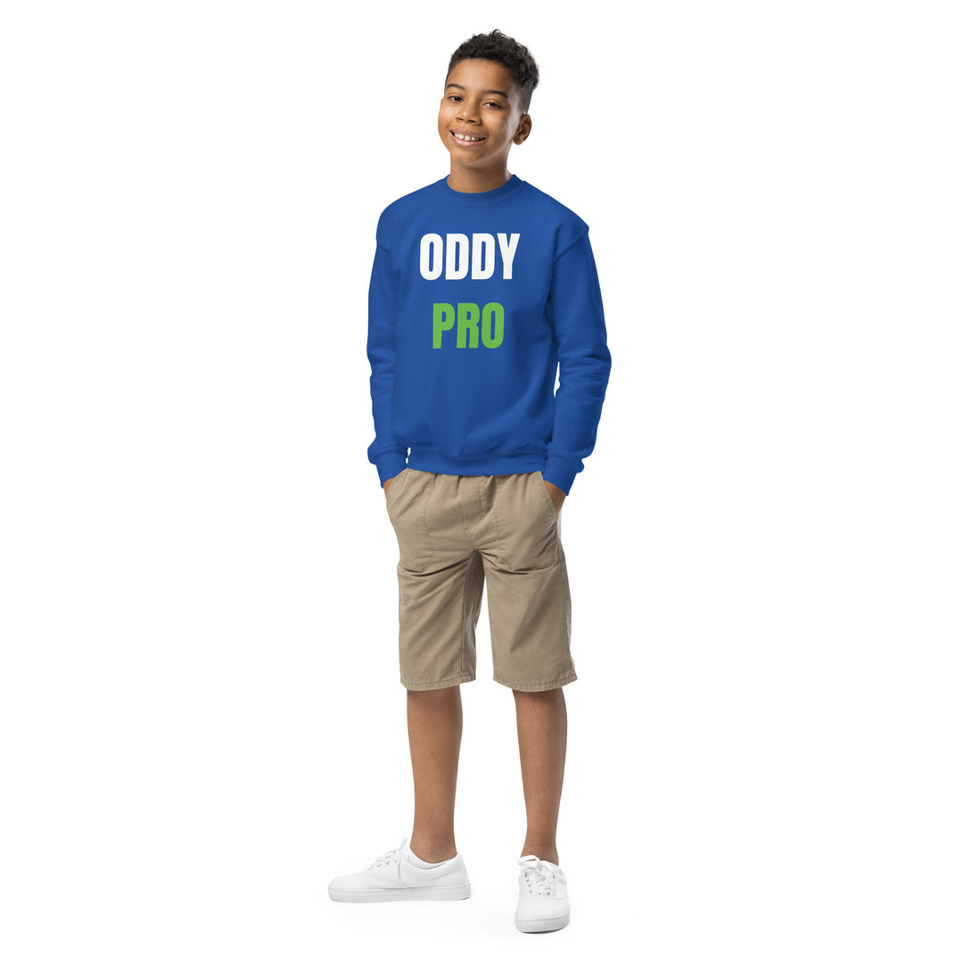 Oddy Pro Youth crewneck sweatshirt on a smiling boy wearing shorts and white sneakers, showcasing a comfortable style.
